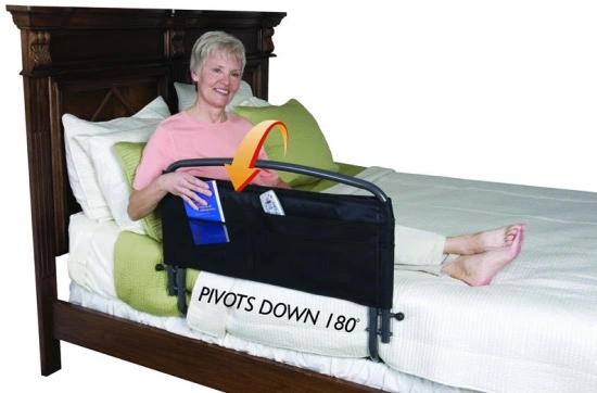 A woman in bed with a bed railing on the side