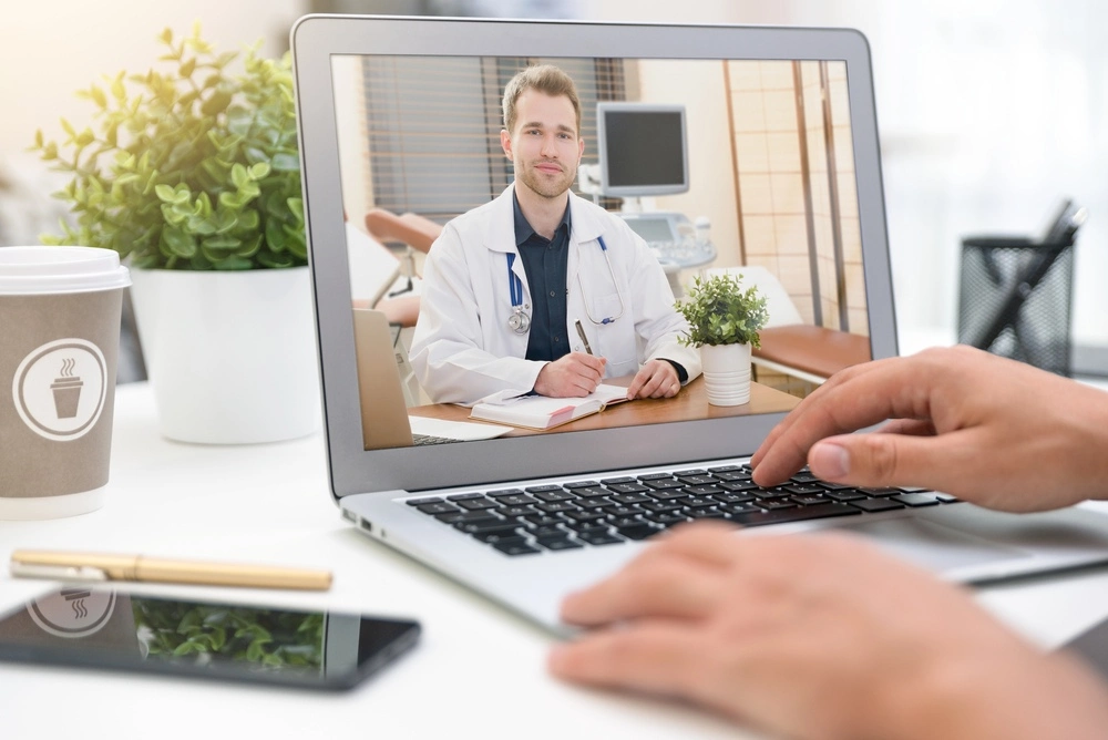 A telemedicine appointment on a laptop.